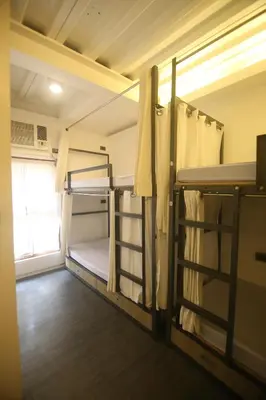 two bunk beds in a room with a window at Quarto Ph in Manila