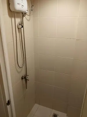 a bathroom with a shower with a toilet and a shower at Quarto Ph in Manila