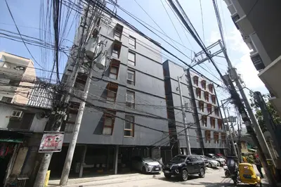 a building with a lot of power lines in front of it at Quarto Ph in Manila