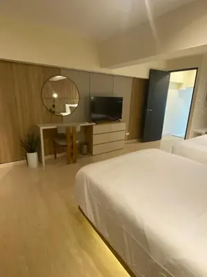 a hotel room with a bed and a mirror at Edsa Heights Unit 3416 Cozy 1 br Loft Penthhouse Unit with 2 full beds Ama Tower in Manila