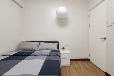 a bedroom with a bed and a white wall at CoZ studio near MAKATI CBD MOA NAIA in Manila