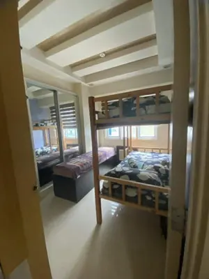 a room with two bunk beds and a mirror at 2br Sea Residences pool view dina in Manila