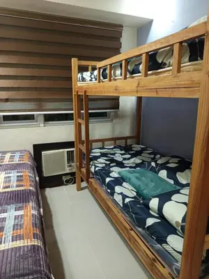 a bedroom with two bunk beds in a room at 2br Sea Residences pool view dina in Manila