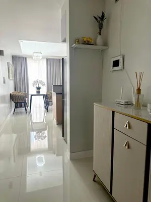 a kitchen with a counter and a table in a room at Modern 1 bedroom spacious apartment with Venice Grand Canal View in Manila