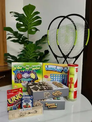 a pile of snacks and a racket on a table at Modern 1 bedroom spacious apartment with Venice Grand Canal View in Manila