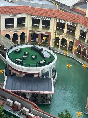 a building with a pool in the middle of the water at Modern 1 bedroom spacious apartment with Venice Grand Canal View in Manila