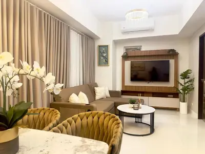 a living room with a couch and a tv at Modern 1 bedroom spacious apartment with Venice Grand Canal View in Manila