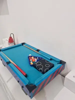 a pool table with balls on top of it at Wowstaycation in Manila