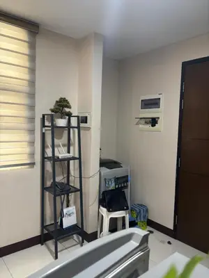 a room with a room with a shelf and a computer at Newport Inn in Manila