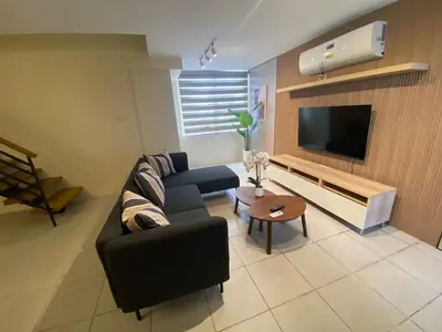 a living room with a couch and a tv at EDSA Heights Unit 3422 Two br Penthouse Loft Unit AMA Tower residences in Manila