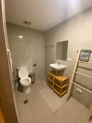 a bathroom with a toilet and a sink at EDSA Heights Unit 3422 Two br Penthouse Loft Unit AMA Tower residences in Manila