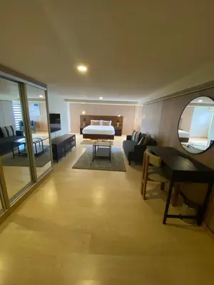 a large living room with a bed and a couch at EDSA Heights Unit 3422 Two br Penthouse Loft Unit AMA Tower residences in Manila
