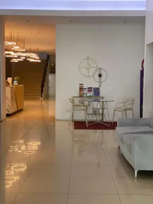 a living room with a table and a couch at EDSA Heights Unit 3422 Two br Penthouse Loft Unit AMA Tower residences in Manila