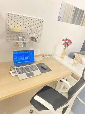a laptop computer sitting on a wooden desk at The Courtyard Contemporary Studio at Taguig WiFi in Manila