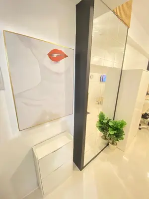 a bathroom with a painting of a red lips at The Courtyard Contemporary Studio at Taguig WiFi in Manila