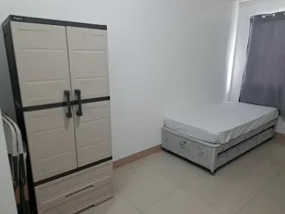 a small bedroom with a bed and a closet at Ivy's CozyStaycation in Dasmariñas