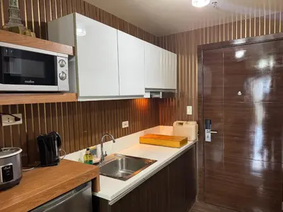 a kitchen with a sink and a microwave at Air Residences MKT in Manila