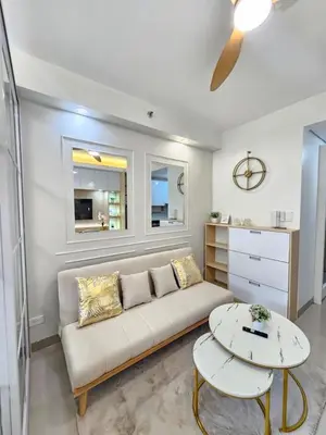 a living room with a couch and a table at Elegant MOA Condo at Shore Residence near the Bay in Manila