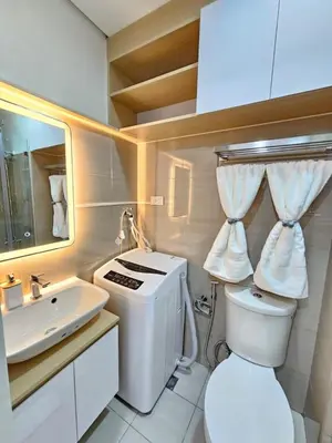 a bathroom with a toilet and a sink at Elegant MOA Condo at Shore Residence near the Bay in Manila