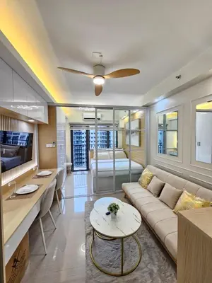 a living room with a couch and a table at Elegant MOA Condo at Shore Residence near the Bay in Manila