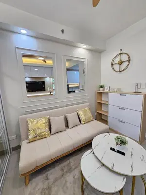 a living room with a couch and a table at Elegant MOA Condo at Shore Residence near the Bay in Manila