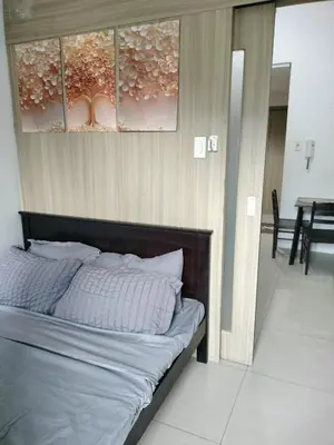 a bedroom with a large bed with white sheets at Amenity Area 2nd floor in Manila