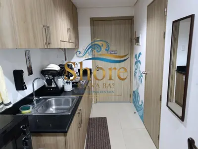 a kitchen with a sink and a sign on the wall at Amenity Area 2nd floor in Manila
