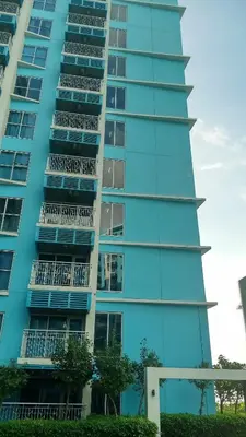 a tall blue building with balconies on it at Charming 1BR with Natural Light in Manila