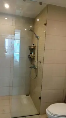 a shower stall with a toilet in a bathroom at Charming 1BR with Natural Light in Manila