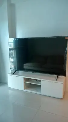 a flat screen tv sitting on top of a table at Charming 1BR with Natural Light in Manila
