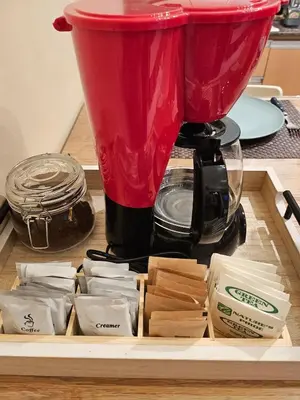 a red blender sitting on top of a table at Elivion Staycations in McKinley Hill BGC with Pool near Venice Mall in Manila