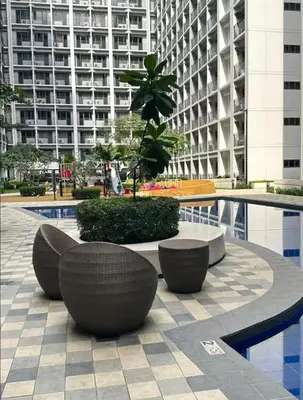 a courtyard with a table and benches in a building at MOA Condotel 1BR fast WiFi in Manila