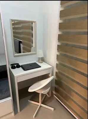 a desk with a mirror and a chair in a room at MOA Condotel 1BR fast WiFi in Manila