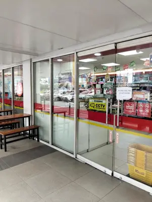 a store with glass doors and a bench in a store at Shell Residences Mall of Asia by Jade in Manila