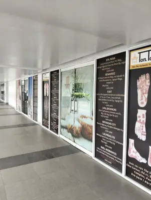 a row of signs on a wall in a building at Shell Residences Mall of Asia by Jade in Manila