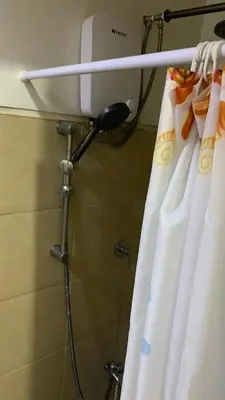 a shower in a bathroom with a shower curtain at Cozy Apartment by Arah in Manila