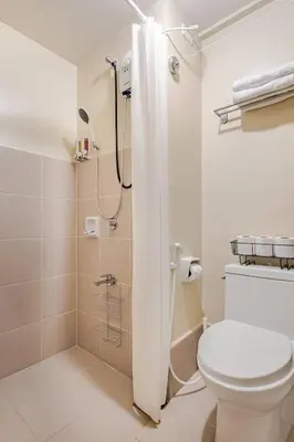 a bathroom with a toilet and a shower at Studio Lune - Heart of Makati in Manila