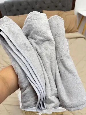 a pair of gray socks sitting on top of a bed at Sofias Townhouse for Rent in Dasmariñas