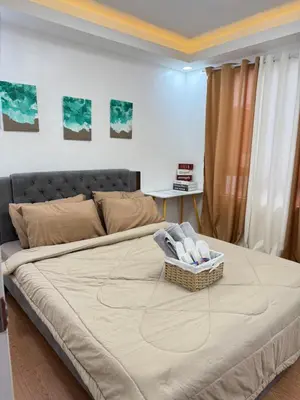 a bedroom with a bed with a basket on it at Sofias Townhouse for Rent in Dasmariñas