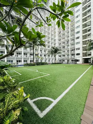 an empty soccer field in front of a building at Shore Residences in Manila