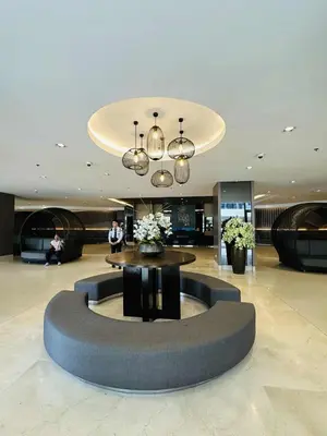 a lobby with a circular table in the middle at Shore Residences in Manila