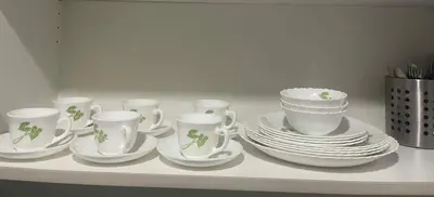 a group of cups and saucers and plates on a shelf at Maison de Joie' in Manila