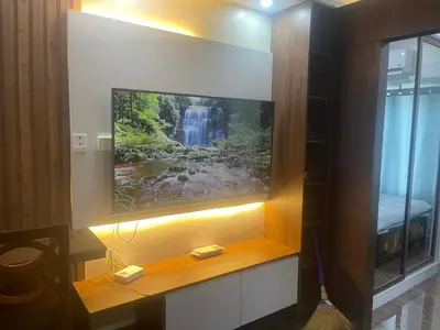 a flat screen tv on a wall with a waterfall at Maison de Joie' in Manila