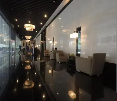a lobby with couches and chairs in a building at Maison de Joie' in Manila