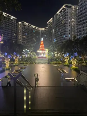 a lit up christmas tree in a city at night at Bahamas tower 1604 in Manila