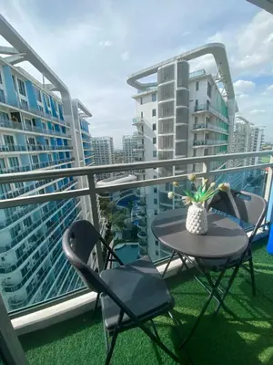 a balcony with a table and chairs on a balcony at Bahamas tower 1604 in Manila