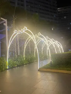 a fountain with lights in a city at night at Bahamas tower 1604 in Manila
