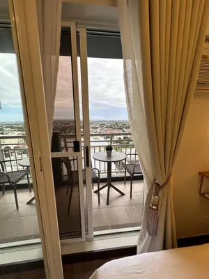 a room with a window with a view of a balcony at The Framehaus with Free Parking at Sonora Garden Residences, Las Pinas in Manila