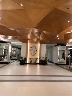 a large lobby with a wooden ceiling in a building at The Framehaus with Free Parking at Sonora Garden Residences, Las Pinas in Manila