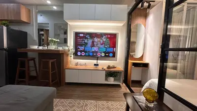 a living room with a flat screen tv on a wall at The Framehaus with Free Parking at Sonora Garden Residences, Las Pinas in Manila